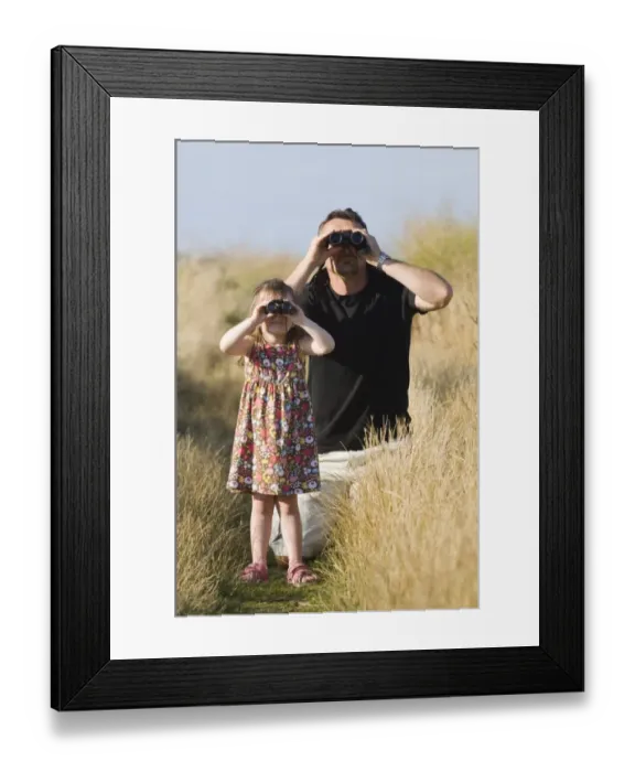 Framed Print : Father and daughter birdwatching at Cley North Norfolk August Framed Print : Father and daughter birdwatching at Cley North Norfolk August