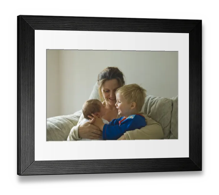 Framed Print : Mother with toddler and new born girl on sofa at home Norfolk UK Framed Print : Mother with toddler and new born girl on sofa at home Norfolk UK