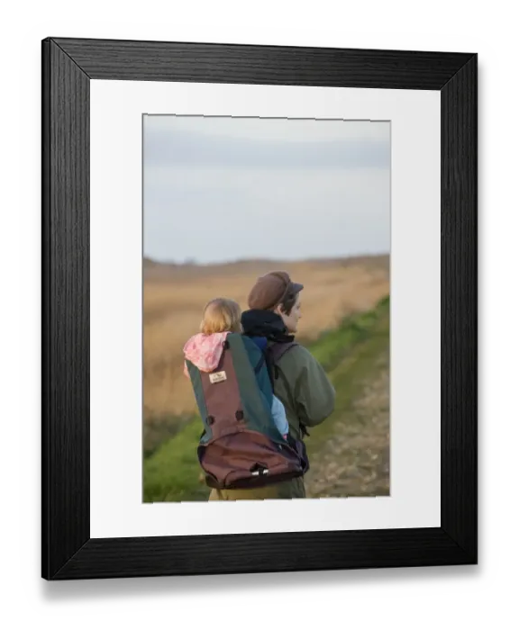 Framed Print : mother carrying toddler in backpack along coastal path North Norfolk winter Framed Print : mother carrying toddler in backpack along coastal path North Norfolk winter