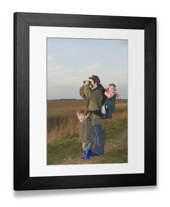 Framed Print : mother carrying toddler in backpack while bird watching along coastal path North