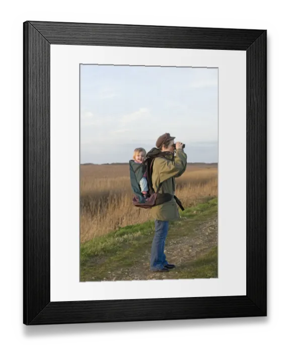 Framed Print : mother carrying toddler in backpack while bird watching along coastal path North Framed Print : mother carrying toddler in backpack while bird watching along coastal path North