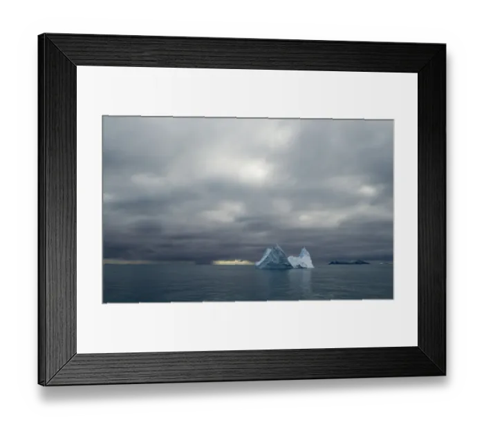 Framed Print : Iceberg and in distance Annekov Island off the rarely visited south west coast of