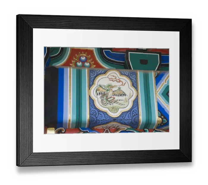 Framed Print : Representation of a Phoenix painted on side of wooden framework below roof of building Framed Print : Representation of a Phoenix painted on side of wooden framework below roof of building