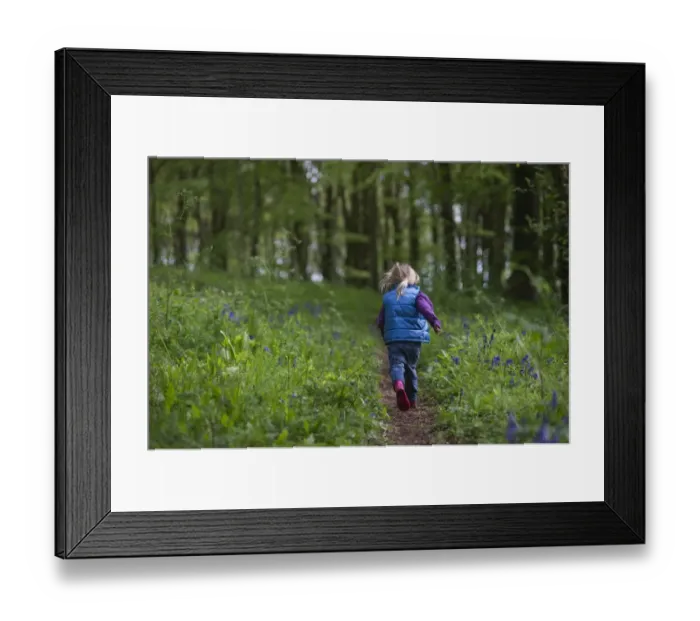 Framed Print : Young girl running along woodland path Norfolk May Framed Print : Young girl running along woodland path Norfolk May