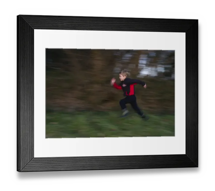 Framed Print : Young boy playing in woodland in winter Norfolk December Framed Print : Young boy playing in woodland in winter Norfolk December