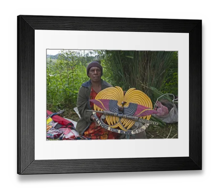 Framed Print : Lady selling wooden carved plaque of Papua New Guinea in design of national emblem Framed Print : Lady selling wooden carved plaque of Papua New Guinea in design of national emblem