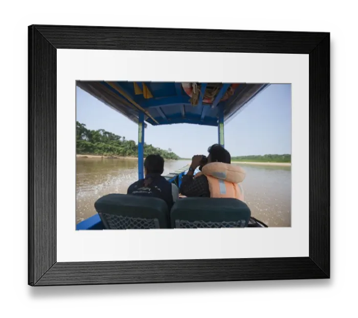 Framed Print : Birdwatching from a motorised canoe along the Tambopata River in the Peruvian Amazon