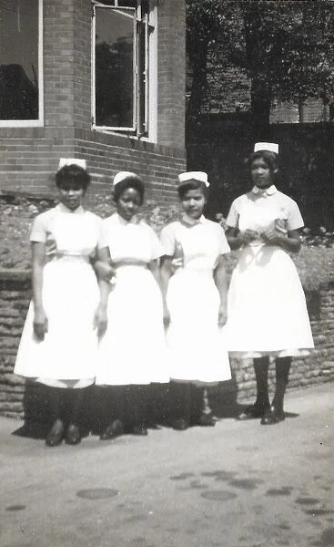 Four black nurses stand by the hospital wall in Nottingham