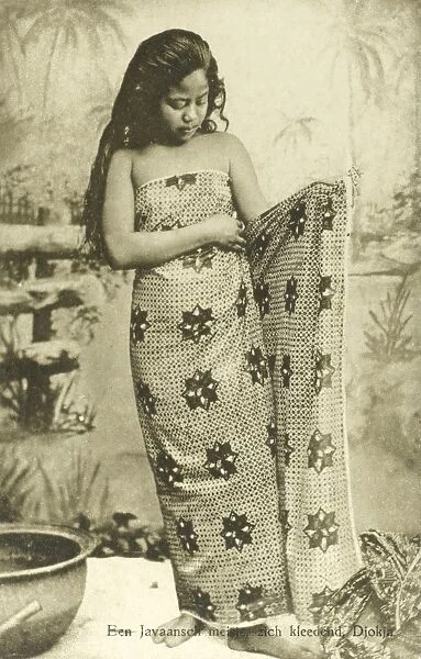 Indonesia - Java - Young girl puts on sarong