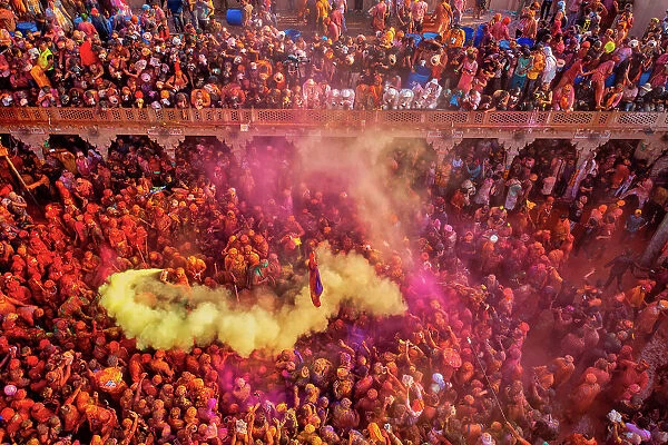 Aerial view of people celebrating the holy colour festival at Shri And Baba Temple, Nandgaon, Uttar Pradesh, India