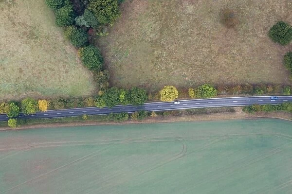 Aerial view of road cutting through countryside south of Norwich Norfolk