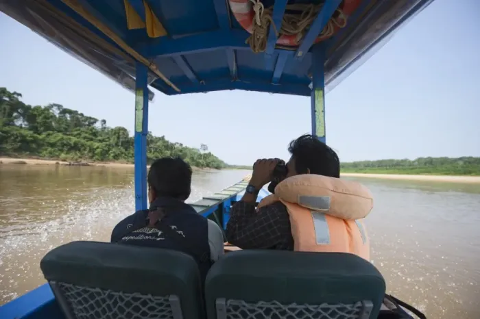 Framed Print : Birdwatching from a motorised canoe along the Tambopata River in the Peruvian Amazon