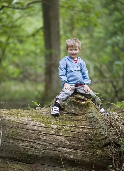 Boy playing in woodland Norfolk spring