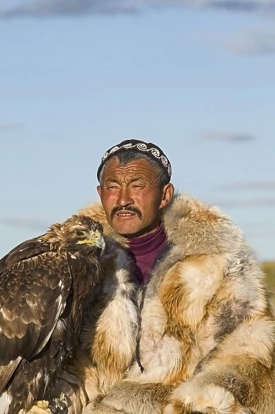 Dalai Han an Kazakh eagle hunter with his Golden Eagle Bayan-Ulgii in Altai Mountains