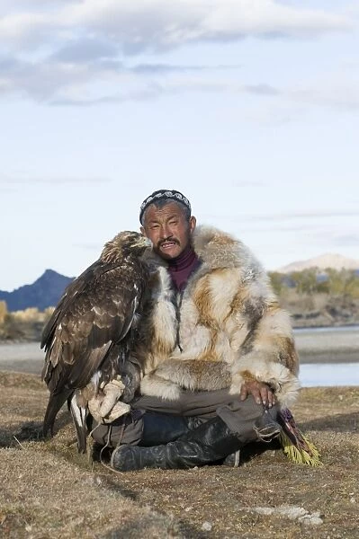 Dalai Han an Kazakh eagle hunter with his Golden Eagle Bayan Ulgii in Altai Mountains