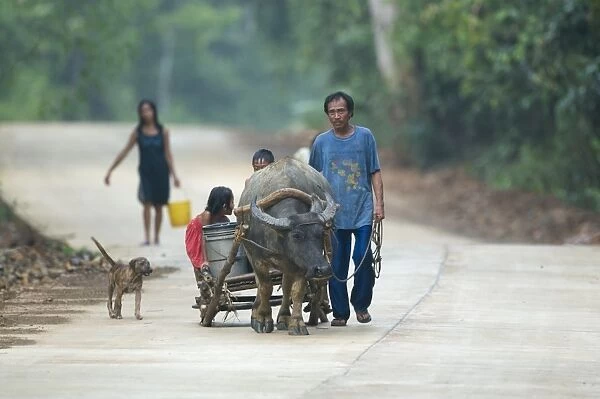 Farming family on way home through forest near Sabang on Palawan Philippines