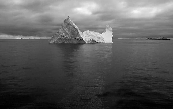 Iceberg and in distance Annekov Island off the rarely visited south west coast of