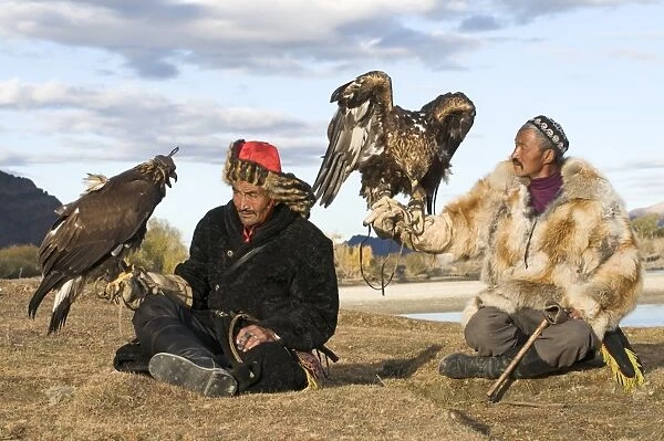 Kazakh eagle hunters with their Golden Eagles Bayan-Ulgii in Altai Mountains western