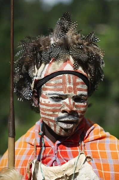 Kikuyu warrior wearing headress made of Helmeted Guineafowl feathers Tomson Falls Kenya