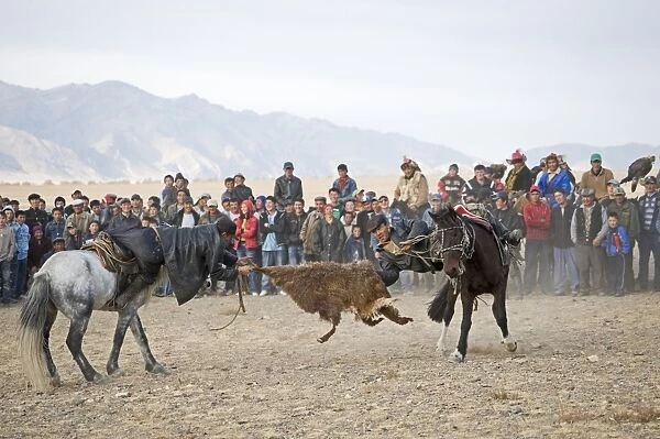 Kurbar tug of war with a goat skin at Eagle Hunters Festival Bayan Ulgi Western Mongolia