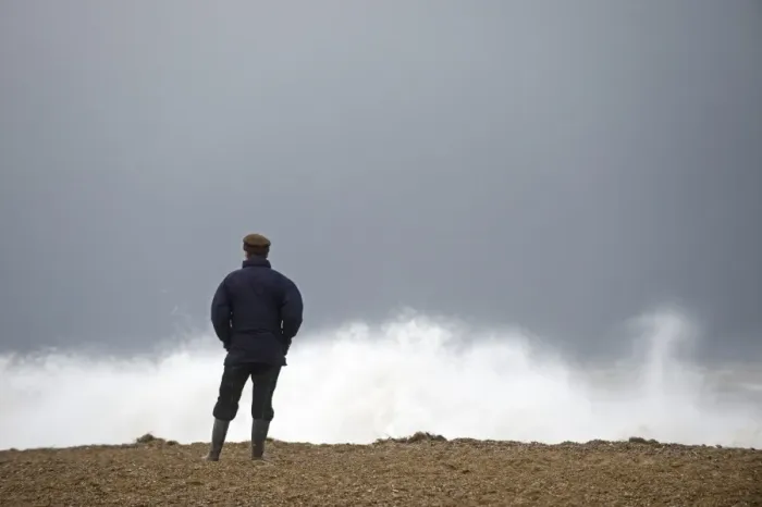 Framed Print : Man looking out across a rough North Sea off Cley Norfolk November Framed Print : Man looking out across a rough North Sea off Cley Norfolk November