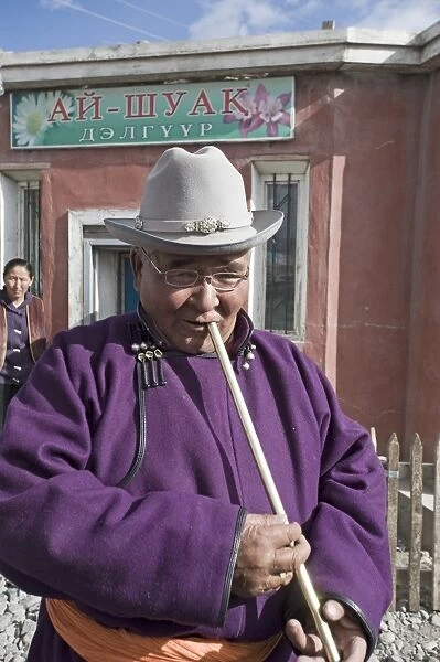 Market trader in Bayan-Ulgii playing a flute western Mongolia