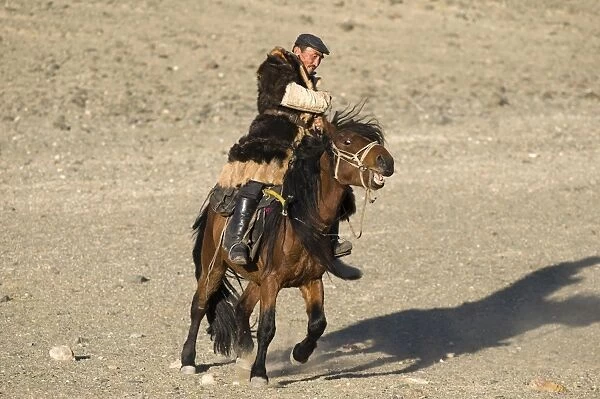 A mongol horseman out on the steppe in Altai mountains near Bayan-Ulgii in western