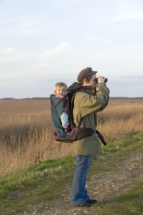 Framed Print : mother carrying toddler in backpack while bird watching along coastal path North Framed Print : mother carrying toddler in backpack while bird watching along coastal path North