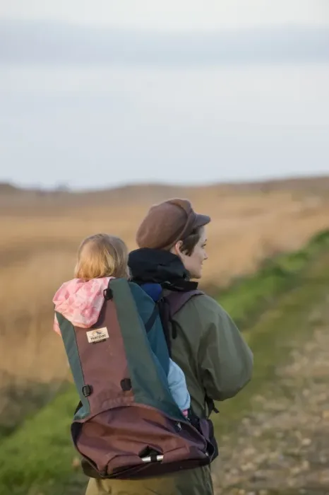 Framed Print : mother carrying toddler in backpack along coastal path North Norfolk winter Framed Print : mother carrying toddler in backpack along coastal path North Norfolk winter