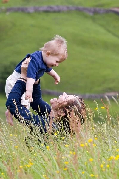 Mother and ten month old boy in field in summer UK