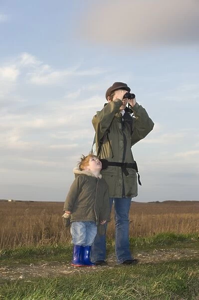 mother and son on bird reserve at Cley Norfolk winter