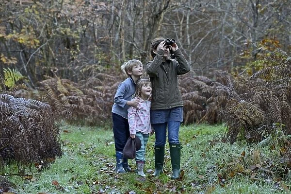 Mother, son and daughter on woodland walk in autumn Norfolk