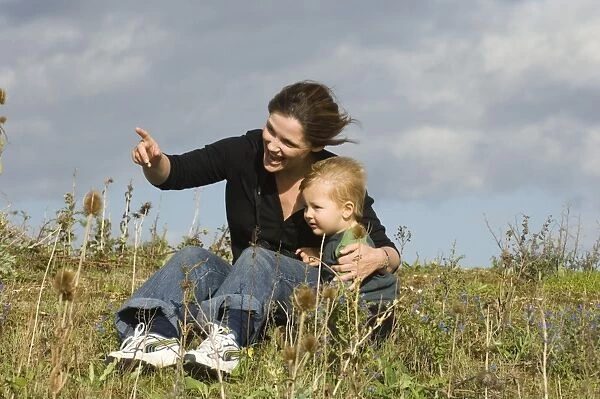 Mother and toddler looking at birds on a windy day at Snettisham RSPB Reserve North