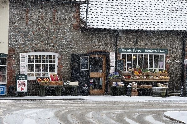 Picnic Fayre shop in falling snow Cley Norfolk in winter