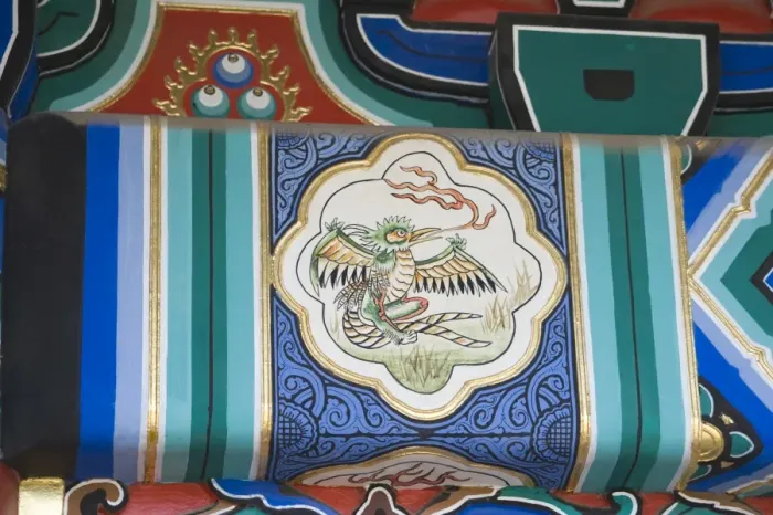 Framed Print : Representation of a Phoenix painted on side of wooden framework below roof of building Framed Print : Representation of a Phoenix painted on side of wooden framework below roof of building