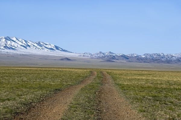 Road across the Gobi Desert below Altai Mountains within Gobi National Park Mongolia