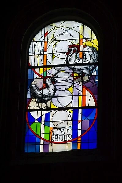 Stained glass window in cathedral Santo Domingo de la Calzada depicting a hen and