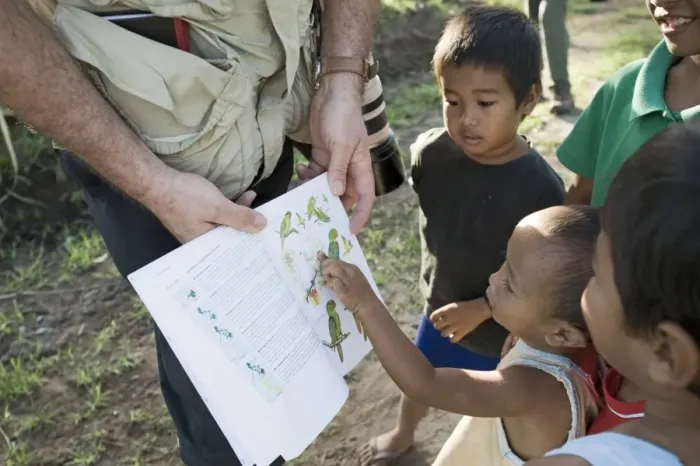 Framed Print : Tim Appleton showing local boys bird illustrations in a field guide at Narra on Palawan Framed Print : Tim Appleton showing local boys bird illustrations in a field guide at Narra on Palawan