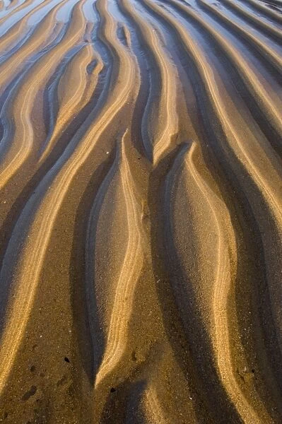 Wave created patterns in sand Northumberland summer