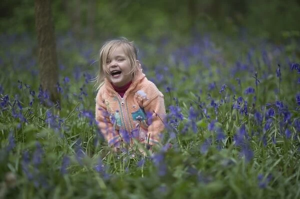 Young girl in Bluebell Wood North Norfolk May UK