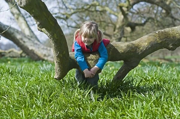 Young girl playing in woods Norfolk in early spring