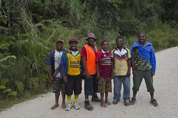 Young men posing for picture on Highlands Highway in Southern Highlands Papua New Guinea