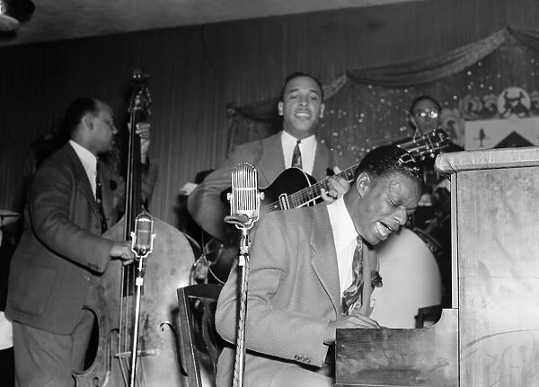 NAT KING COLE (1919-1965). American musician. Performing with the Nat King Cole Trio