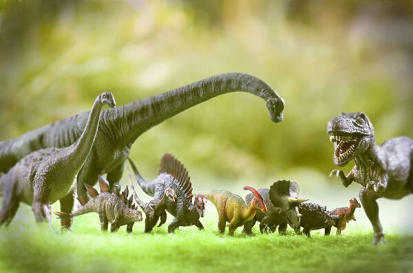 Group of toy dinosaurs in outdoor scenery