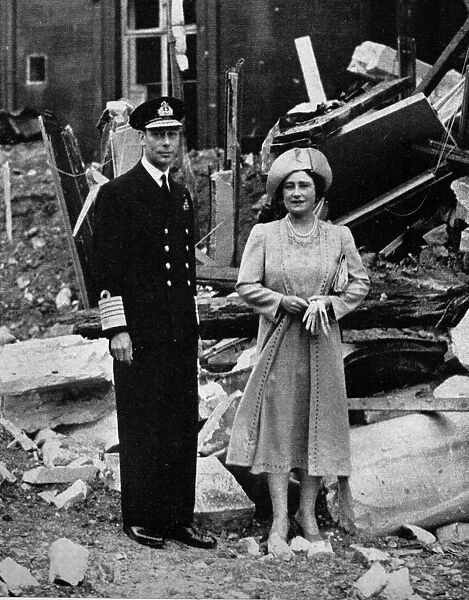 King George V and Queen Elizabeth, stand in the ruins of Buckingham Palace after
