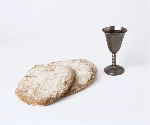 Medieval flatbreads known as bread plates, and pewter goblet, close-up