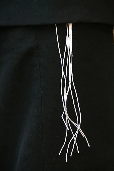 Tallit Katan (small talit or taleth) threads over suit