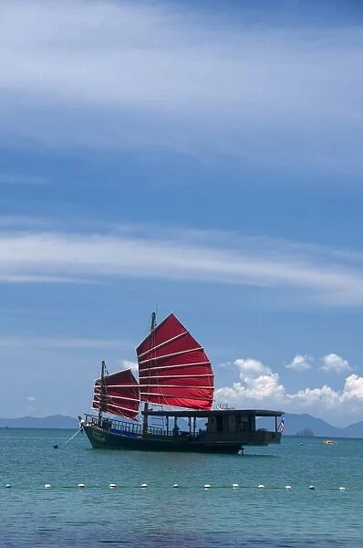 Thailand, Krabi Coast, a junk with red sails off Hat Tham Phra Nang beach