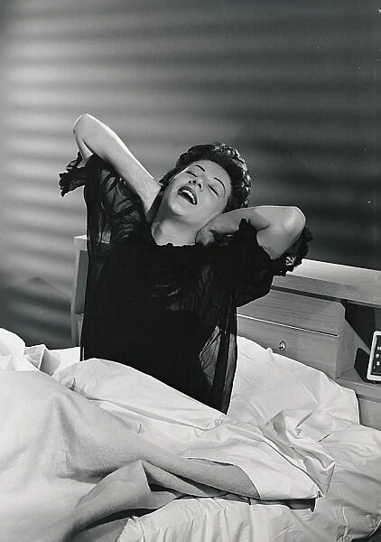 Woman waking up from her bed