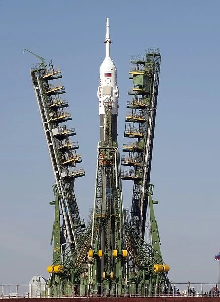 Launch scaffolding is raised into place around the Soyuz rocket